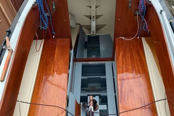 Slide: The Image of 1946 Luders L-16 sailboat interior with polished wood finish and nautical ropes. - 7