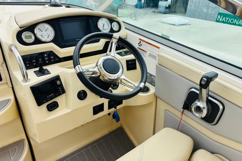 Slide: The Image of 2019 Regal 28 Express boat dashboard with steering wheel and control panel. - 12