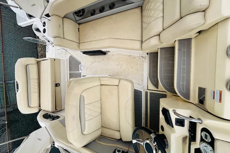 Slide: The Image of 2019 Regal 28 Express boat interior with beige seating and modern dashboard. - 15
