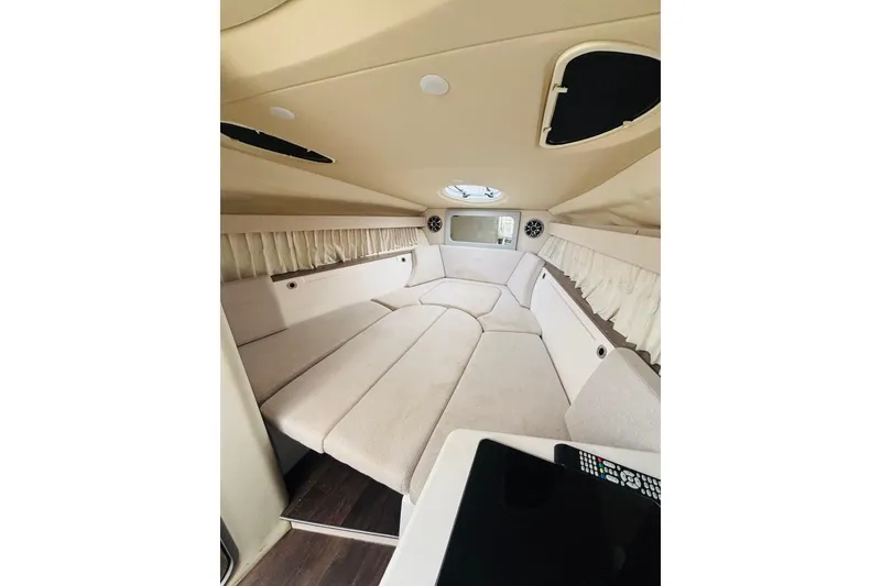 Slide: The Image of Interior cabin of 2019 Regal 28 Express boat, featuring beige upholstery and modern design. - 17
