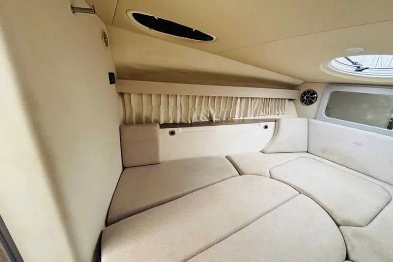 Slide: The Image of 2019 Regal 28 Express cabin interior with beige upholstery and circular window. - 18
