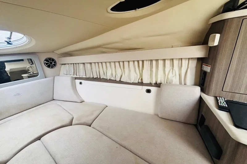 Slide: The Image of Interior of 2019 Regal 28 Express boat with beige seating and wood accents. - 19