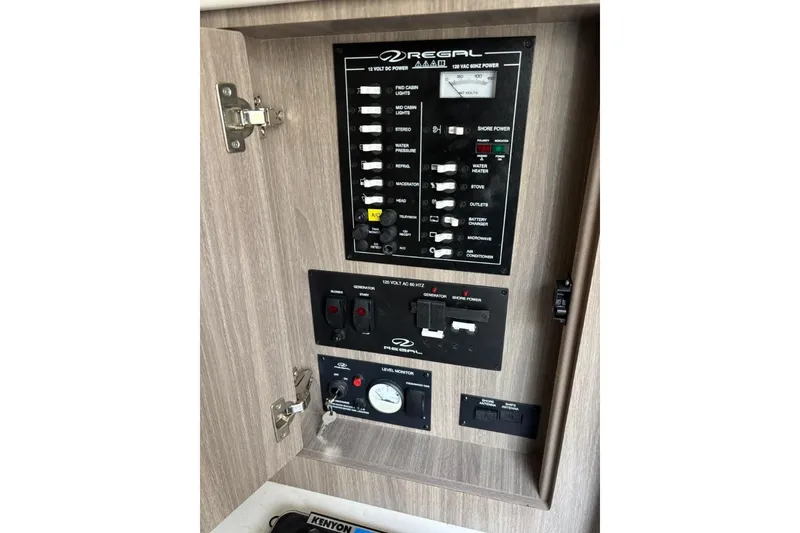 Slide: The Image of Control panel of a 2019 Regal 28 Express boat, featuring switches and gauges. - 24