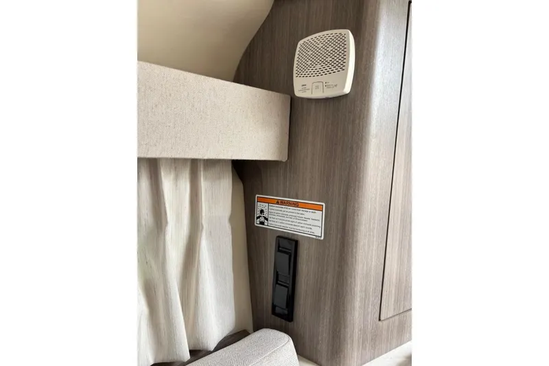 Slide: The Image of Interior of 2019 Regal 28 Express boat with smoke detector and warning label. - 28