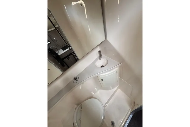 Slide: The Image of Compact bathroom in 2019 Regal 28 Express boat with sink and mirror. - 33