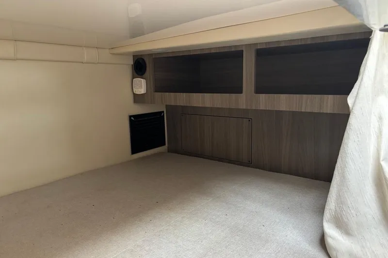 Slide: The Image of 2019 Regal 28 Express cabin interior with wood paneling and storage compartments. - 35