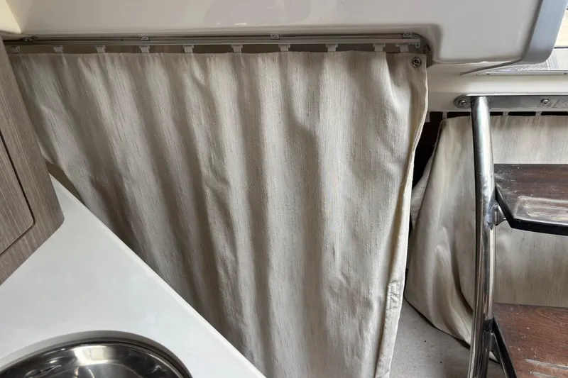 Slide: The Image of Interior of 2019 Regal 28 Express boat with curtain and sink. - 36