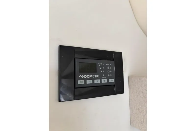 Slide: The Image of Dometic control panel on 2019 Regal 28 Express boat interior wall. - 39