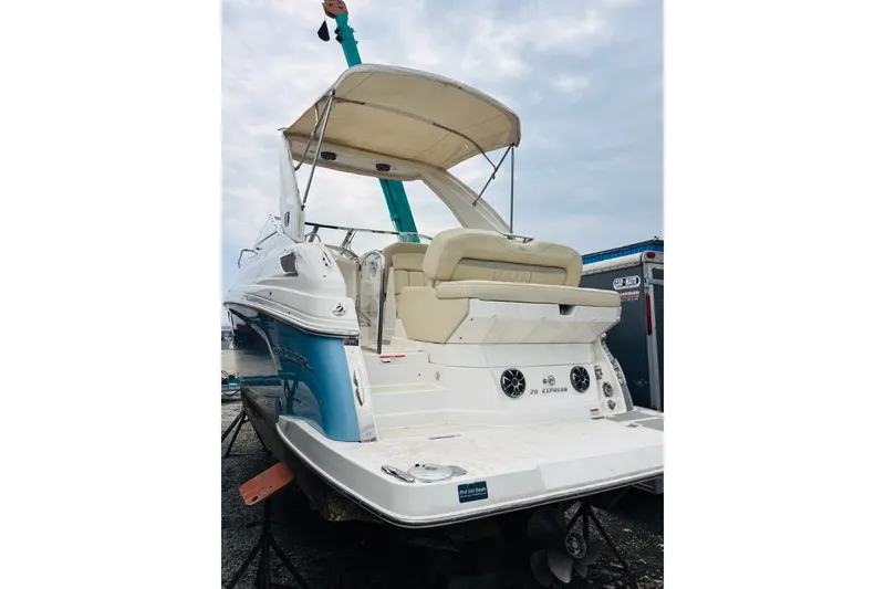 Slide: The Image of 2019 Regal 28 Express boat with canopy, docked on land. - 42