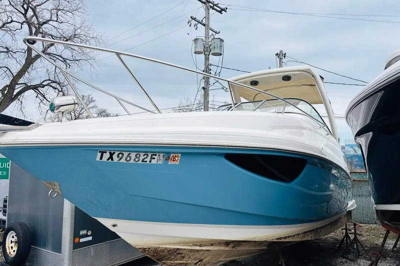 Slide: The Image of 2019 Regal 28 Express boat with blue hull, docked outdoors. - 44