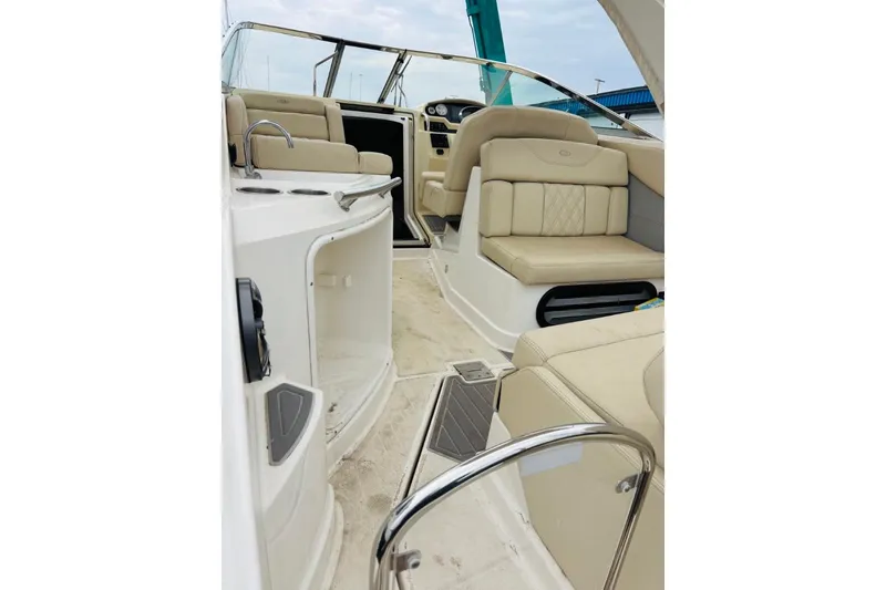 Slide: The Image of 2019 Regal 28 Express boat interior with beige seating and modern dashboard. - 46