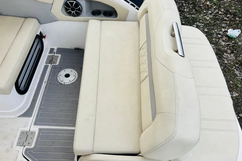 Slide: The Image of 2019 Regal 28 Express boat interior with beige seating and speaker detail. - 5
