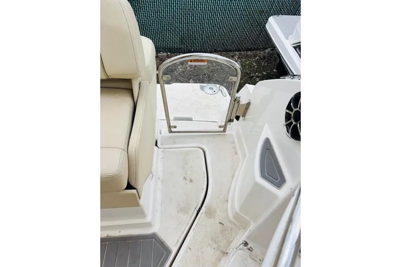 Slide: The Image of 2019 Regal 28 Express boat interior with seating and open gate. - 8