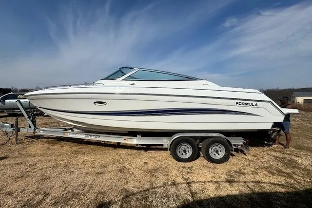 Slide: The Image of 2007 Formula 280 Bowrider boat on trailer under clear sky. - 2