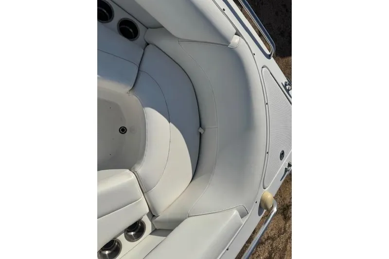 Slide: The Image of 2007 Formula 280 Bowrider boat interior with white seating and cup holders. - 22