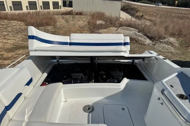 Slide: The Image of 2007 Formula 280 Bowrider boat interior with open engine compartment, white and blue seating. - 25