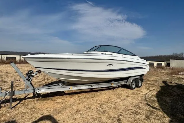 Slide: The Image of 2007 Formula 280 Bowrider boat on trailer, parked outdoors under clear sky. - 5