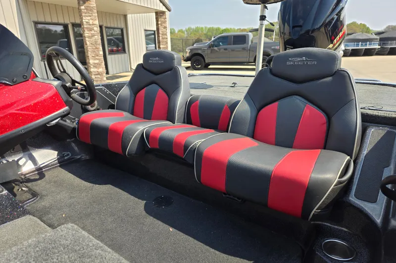 Slide: The Image of 2019 Skeeter ZX250 boat interior with red and black seating, steering wheel, and console. - 12