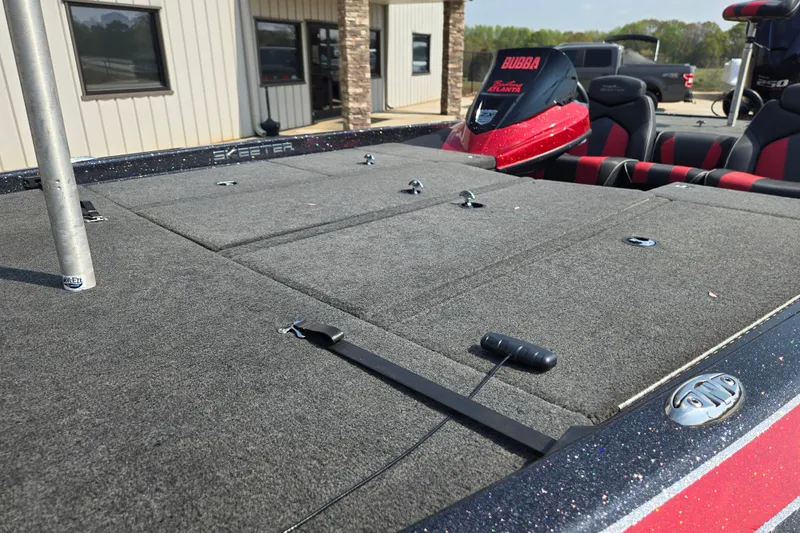 Slide: The Image of 2019 Skeeter ZX250 boat deck with carpeted surface and storage compartments. - 13