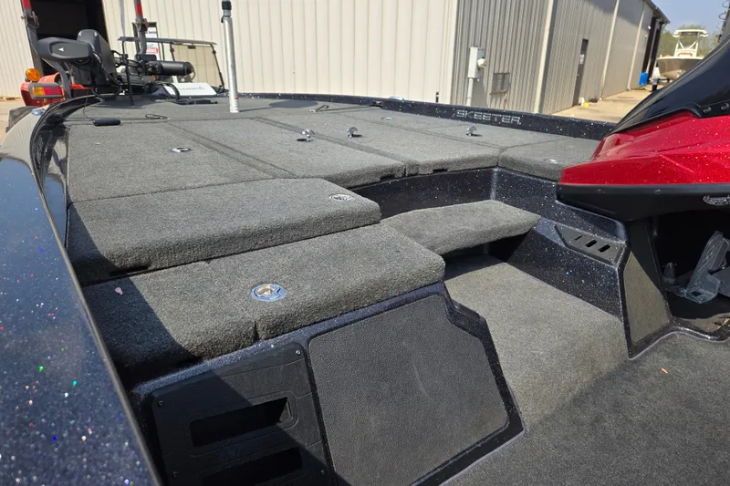 Slide: The Image of 2019 Skeeter ZX250 boat interior with carpeted deck and storage compartments. - 15