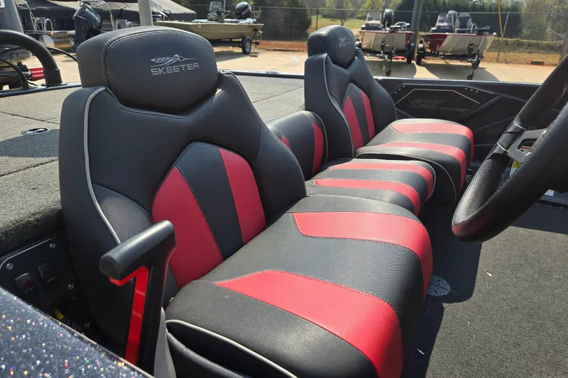 Slide: The Image of 2019 Skeeter ZX250 boat interior with red and black seats, steering wheel visible. - 18