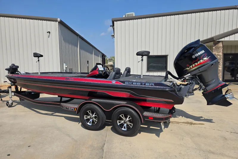 The Image of 2019 Skeeter ZX250 bass boat with Yamaha engine, parked outside a warehouse. - 2