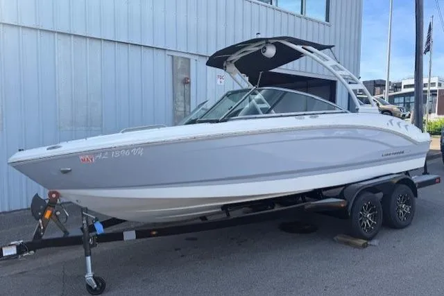 The Image of 2023 Chaparral 21 SSi boat on trailer, parked outside a building. - 0