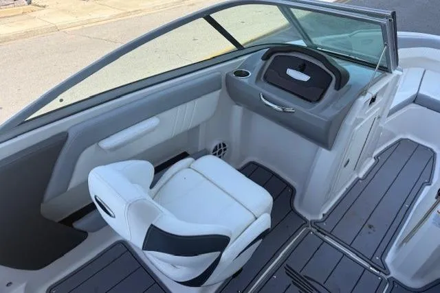 Slide: The Image of 2023 Chaparral 21 SSi boat interior with white seating and sleek dashboard design. - 12