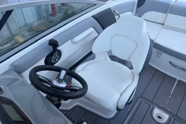 Slide: The Image of 2023 Chaparral 21 SSi boat interior with white seating and steering wheel. - 13