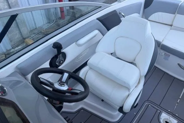 Slide: The Image of 2023 Chaparral 21 SSi boat interior with white captain's seat and steering wheel. - 14