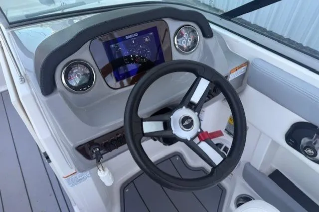 Slide: The Image of 2023 Chaparral 21 SSi boat dashboard with steering wheel and digital display. - 16