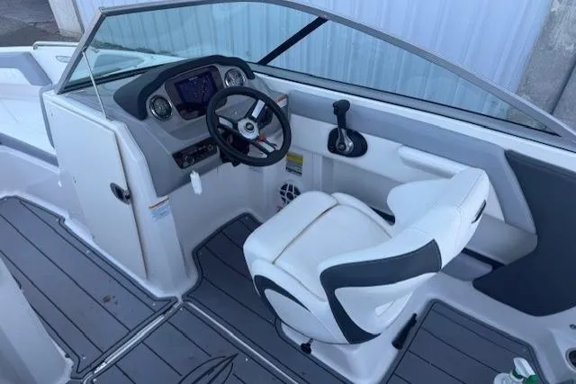 Slide: The Image of 2023 Chaparral 21 SSi boat cockpit with steering wheel and modern dashboard. - 18