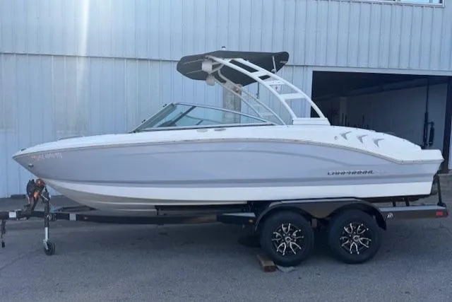 Slide: The Image of 2023 Chaparral 21 SSi boat on trailer, sleek design, white exterior. - 2