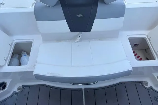 Slide: The Image of 2023 Chaparral 21 SSi boat interior with storage compartments and cushioned seating. - 21