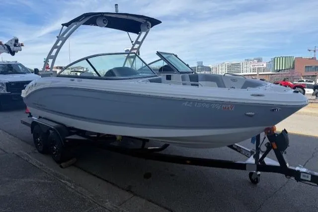 Slide: The Image of 2023 Chaparral 21 SSi boat on trailer, parked on urban street. - 6