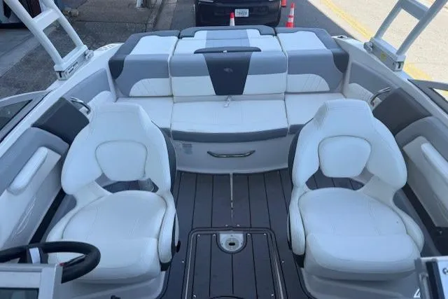Slide: The Image of 2023 Chaparral 21 SSi boat interior with white seating and modern design. - 9