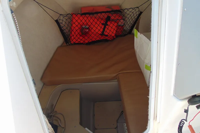 Slide: The Image of 2009 Trophy 1902 Walkaround cabin interior with cushions and safety gear. - 17