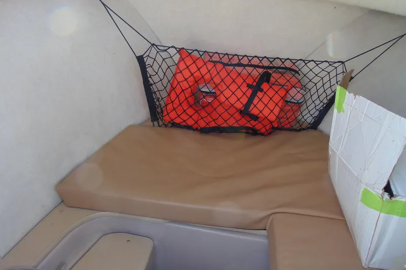 Slide: The Image of Interior of 2009 Trophy 1902 Walkaround boat with life jacket and storage net. - 18