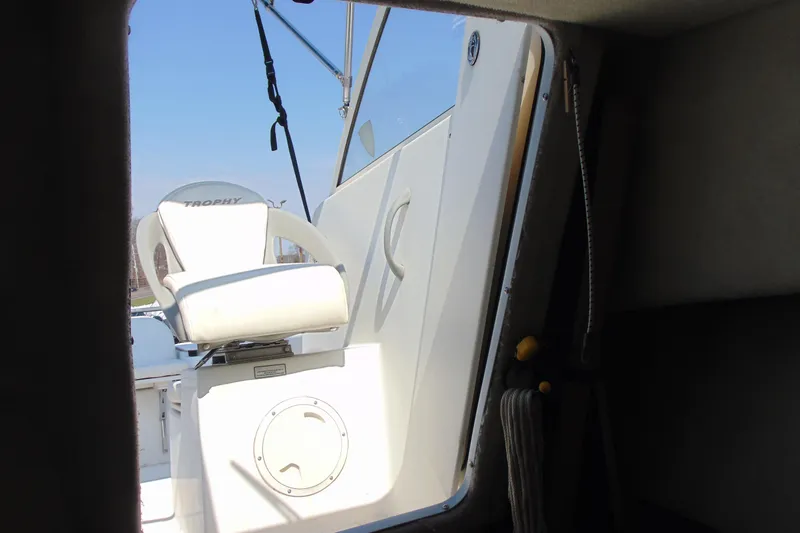 Slide: The Image of 2009 Trophy 1902 Walkaround boat interior with white seating and clear sky. - 20