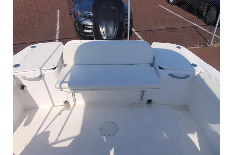Slide: The Image of 2009 Trophy 1902 Walkaround boat interior with white seating and storage compartments. - 9