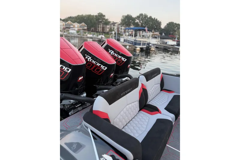 Slide: The Image of 2026 Statement 350 Open boat with powerful racing engines at a marina. - 11