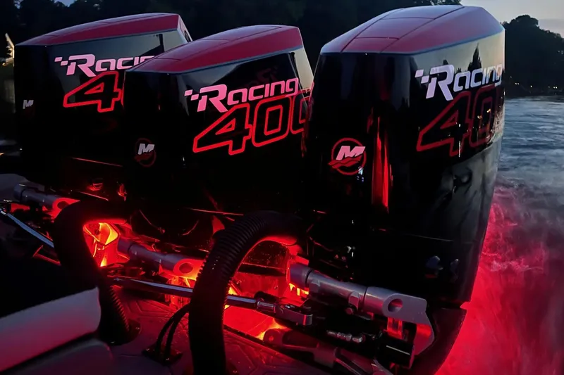 Slide: The Image of Powerful Mercury Racing 400 outboard engines on Statement 350 Open, 2026 model, illuminated at dusk. - 13
