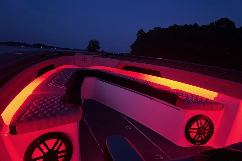 Slide: The Image of Luxurious 2026 Statement 350 Open boat interior with vibrant red LED lighting at dusk. - 15