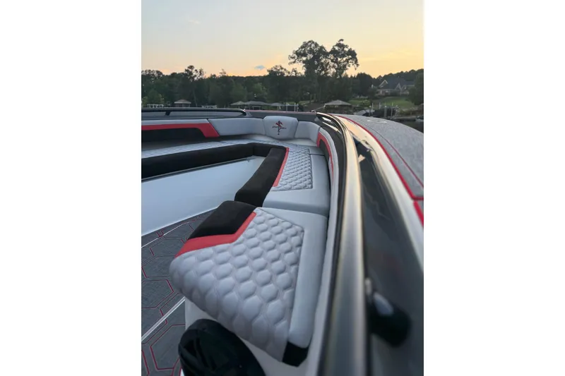 Slide: The Image of 2026 Statement 350 Open boat interior with stylish seating at sunset. - 6