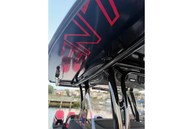 Slide: The Image of 2026 Statement 350 Open boat with sleek design and red accents, docked by the water. - 8