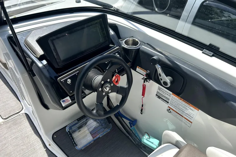 Slide: The Image of Cockpit of 2020 Scarab 255 ID boat with steering wheel and control panel. - 17