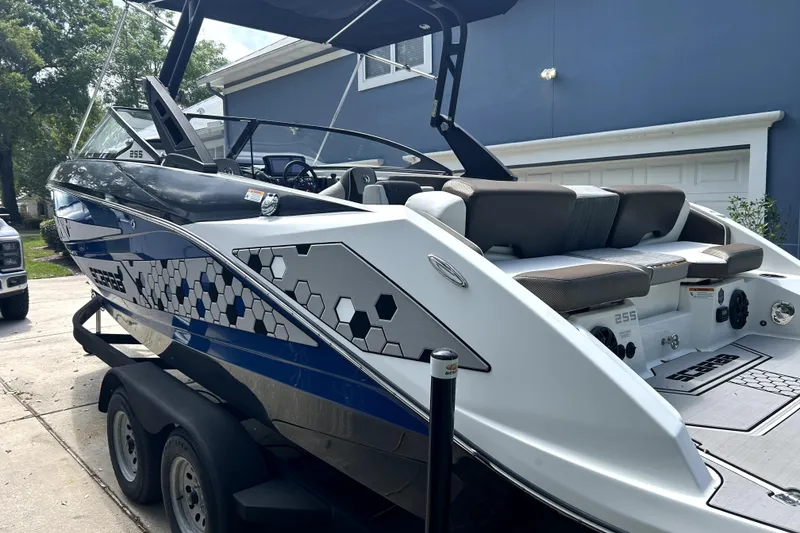 Slide: The Image of 2020 Scarab 255 ID boat on trailer, featuring sleek design and modern graphics. - 2