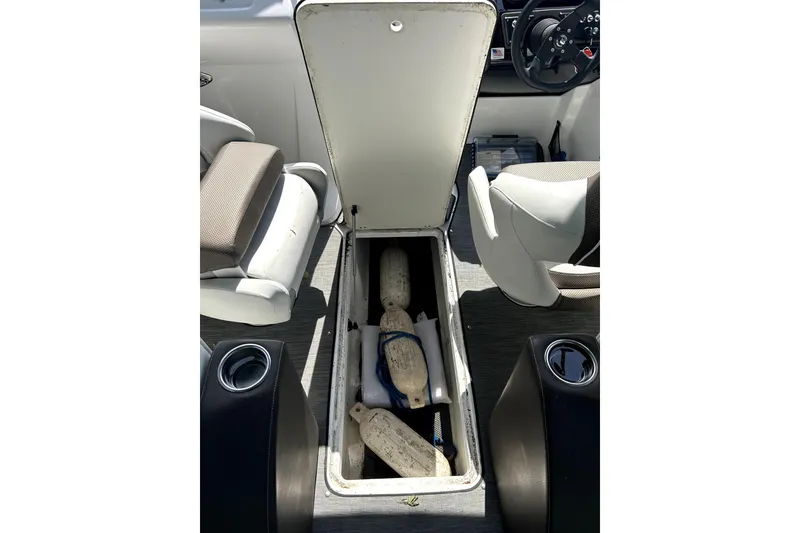 Slide: The Image of Open storage compartment in 2020 Scarab 255 ID boat interior. - 21