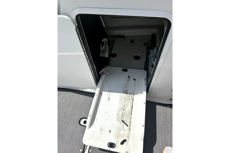 Slide: The Image of Open storage compartment on a 2020 Scarab 255 ID boat, showing interior details. - 25