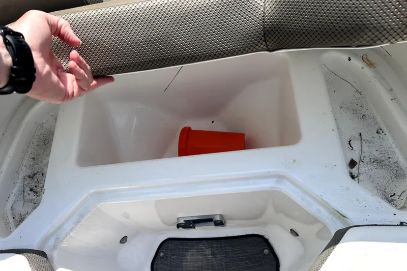 Slide: The Image of Boat storage compartment in a 2020 Scarab 255 ID with an orange bucket inside. - 28